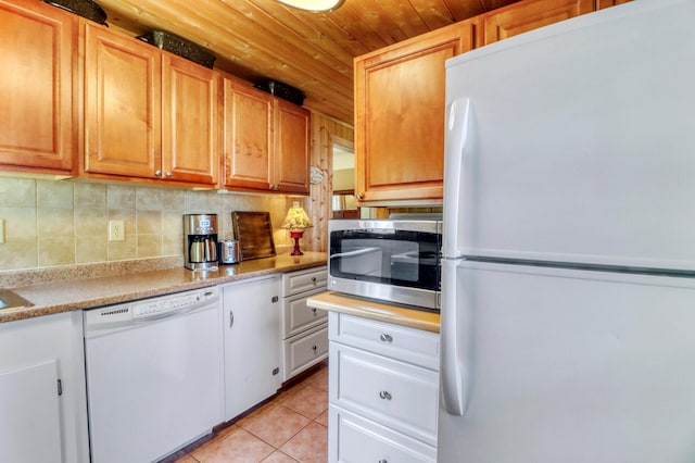 20473 Leisure Dr, Pelican Rapids, MN 56572 - kitchen featuring white appliances, wood ceiling, light tile patterned floors, light countertops, and backsplash
