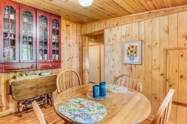20473 Leisure Dr, Pelican Rapids, MN 56572 - dining room featuring wooden walls, light wood finished floors, and wood ceiling