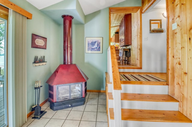 20473 Leisure Dr, Pelican Rapids, MN 56572 - stairway featuring a wood stove, tile patterned floors, and baseboards
