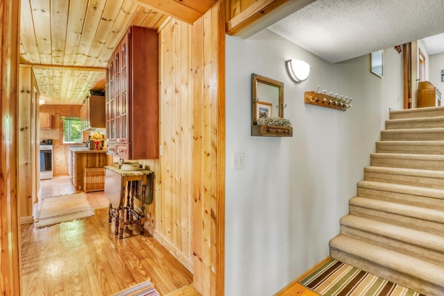 20473 Leisure Dr, Pelican Rapids, MN 56572 - staircase featuring wood finished floors, wooden walls, and baseboards
