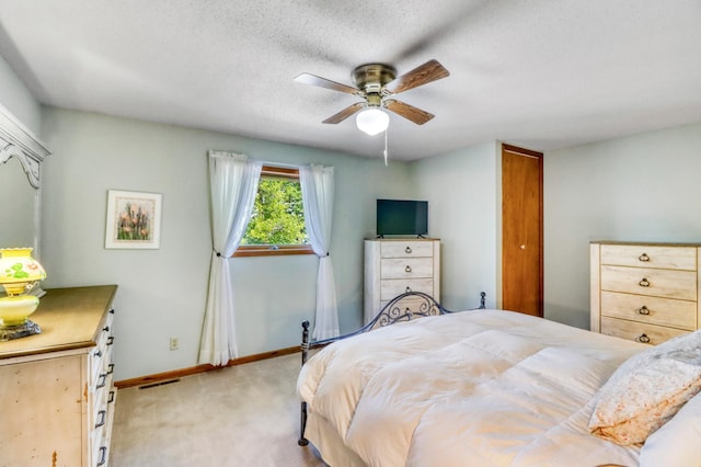 20473 Leisure Dr, Pelican Rapids, MN 56572 - bedroom with light carpet, baseboards, a ceiling fan, and a textured ceiling