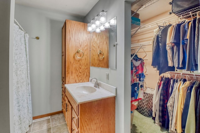 20473 Leisure Dr, Pelican Rapids, MN 56572 - bathroom featuring vanity, a walk in closet, and baseboards