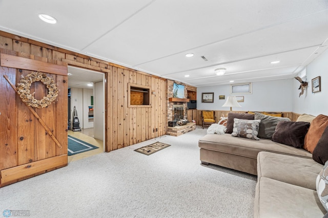 2020 5th St S, Moorhead, MN 56560 - carpeted living room featuring wooden walls, recessed lighting, and a fireplace