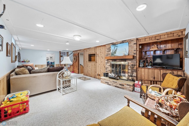 2020 5th St S, Moorhead, MN 56560 - carpeted living room with wooden walls, a fireplace, and recessed lighting