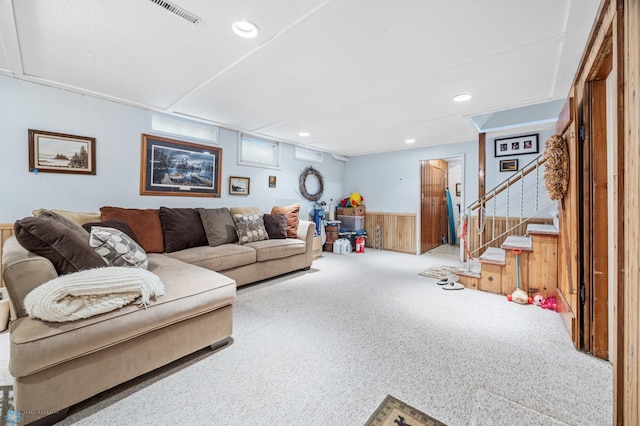 2020 5th St S, Moorhead, MN 56560 - carpeted living room featuring wainscoting, stairs, wooden walls, and recessed lighting