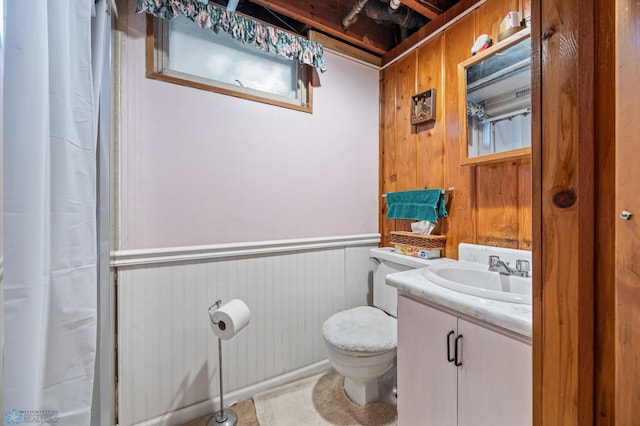 2020 5th St S, Moorhead, MN 56560 - full bathroom featuring toilet, wooden walls, vanity, a shower with curtain, and a wainscoted wall