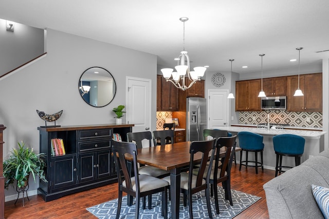 12266 Midway Cir NE, Blaine, MN 55449 - dining space with dark wood-type flooring, a chandelier, recessed lighting, and baseboards