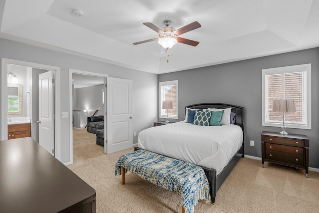 12266 Midway Cir NE, Blaine, MN 55449 - bedroom with a raised ceiling, light colored carpet, ceiling fan, and baseboards