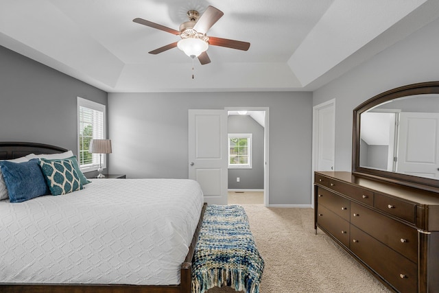 12266 Midway Cir NE, Blaine, MN 55449 - bedroom with a raised ceiling, multiple windows, and light carpet