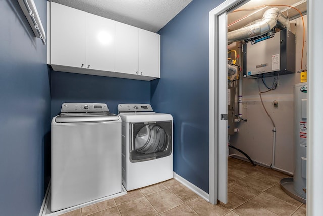 12266 Midway Cir NE, Blaine, MN 55449 - laundry area with cabinet space, washing machine and dryer, electric water heater, light tile patterned flooring, and baseboards