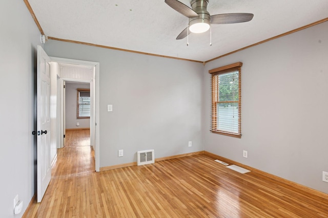426 14th Ave N, Hopkins, MN 55343 - unfurnished room with crown molding, light wood-type flooring, a ceiling fan, and baseboards