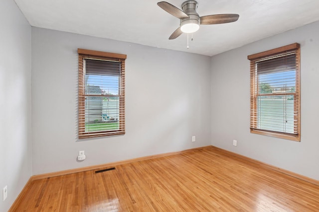 426 14th Ave N, Hopkins, MN 55343 - empty room with healthy amount of natural light, light wood-style floors, baseboards, and ceiling fan
