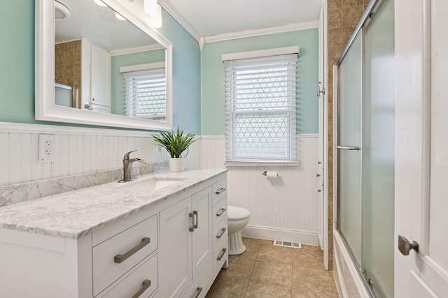 426 14th Ave N, Hopkins, MN 55343 - bathroom with wainscoting, an enclosed shower, vanity, toilet, and ornamental molding