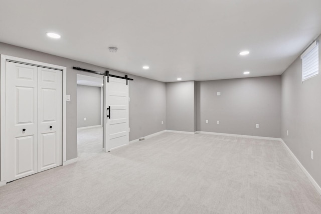 426 14th Ave N, Hopkins, MN 55343 - below grade area featuring a barn door, light carpet, recessed lighting, and baseboards