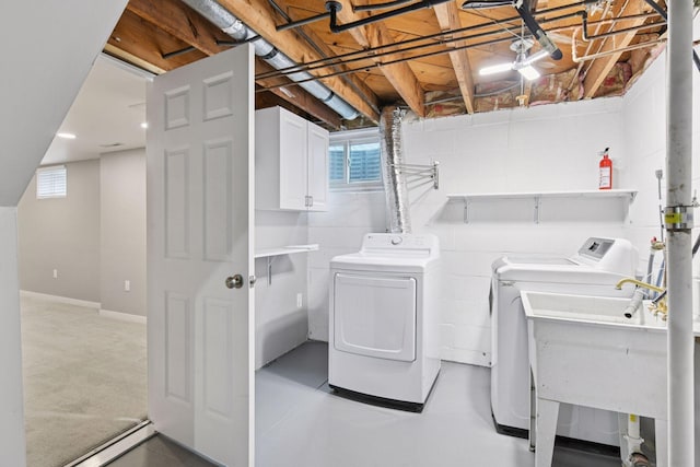 426 14th Ave N, Hopkins, MN 55343 - laundry area with cabinet space, washer and clothes dryer, and plenty of natural light
