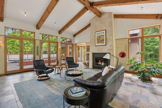 20545 Linden Rd, Deephaven, MN 55331 - living area with stone tile flooring, healthy amount of natural light, high vaulted ceiling, a fireplace, and beamed ceiling
