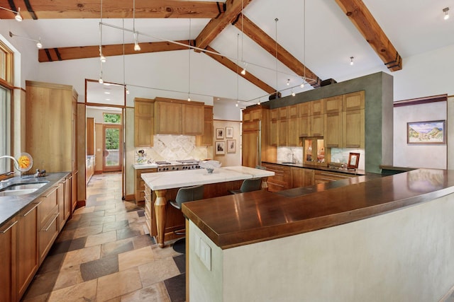 20545 Linden Rd, Deephaven, MN 55331 - kitchen featuring a sink, decorative backsplash, a large island, stone tile floors, and beamed ceiling