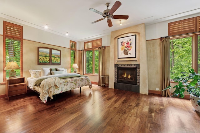 20545 Linden Rd, Deephaven, MN 55331 - bedroom with wood finished floors, multiple windows, a tiled fireplace, and baseboards