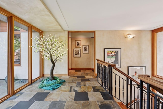 20545 Linden Rd, Deephaven, MN 55331 - hallway featuring stone finish floors, baseboards, and an upstairs landing