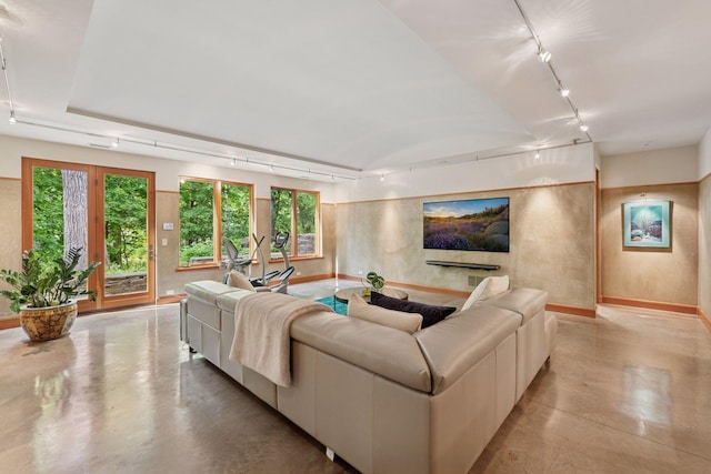 20545 Linden Rd, Deephaven, MN 55331 - living area featuring rail lighting, finished concrete flooring, and baseboards