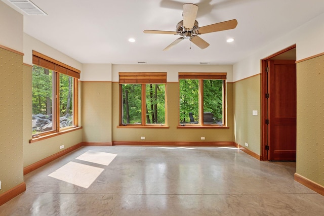 20545 Linden Rd, Deephaven, MN 55331 - unfurnished room with healthy amount of natural light, ceiling fan, baseboards, concrete flooring, and recessed lighting