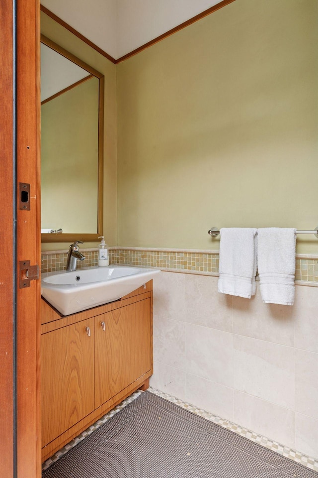 20545 Linden Rd, Deephaven, MN 55331 - bathroom featuring vanity, a wainscoted wall, and tile walls