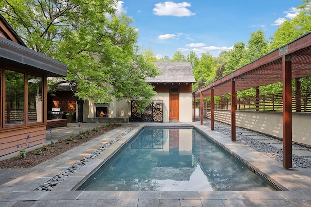 20545 Linden Rd, Deephaven, MN 55331 - view of pool featuring a lit fireplace and a patio area