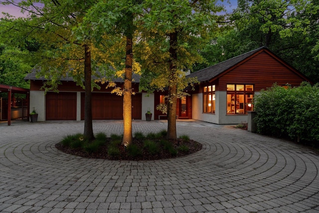 20545 Linden Rd, Deephaven, MN 55331 - view of front of house featuring curved driveway, stucco siding, and a garage