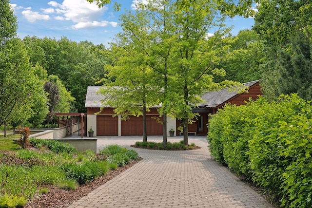 20545 Linden Rd, Deephaven, MN 55331 - view of property hidden behind natural elements featuring an attached garage and driveway