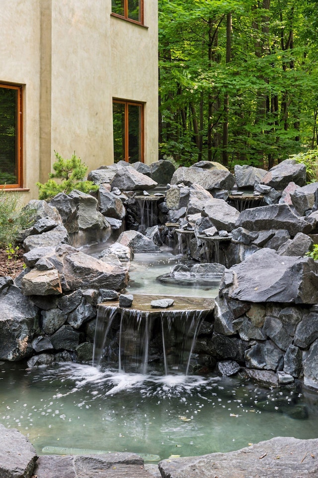 20545 Linden Rd, Deephaven, MN 55331 - exterior view of stucco siding and a garden pond