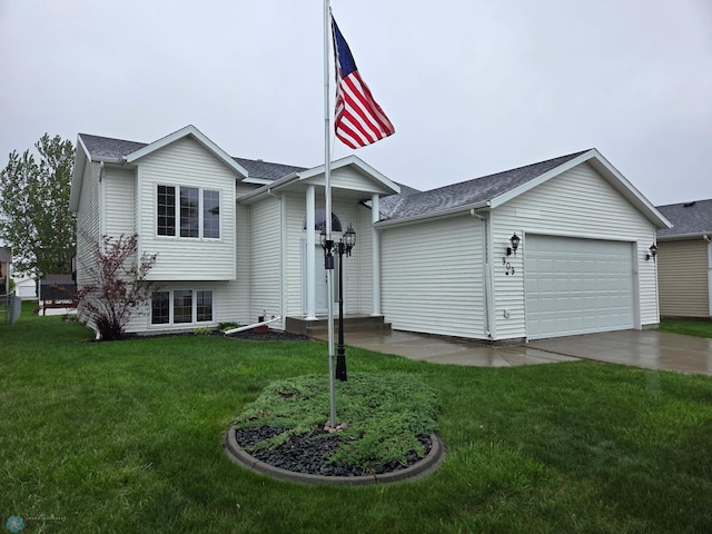 split level home featuring a garage, driveway, a front yard, and roof with shingles