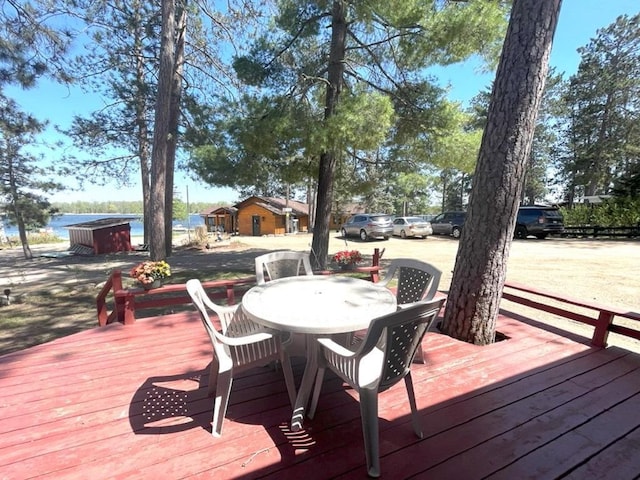 25186 US-71 # 18, Park Rapids, MN 56470 - wooden terrace with outdoor dining area and a water view