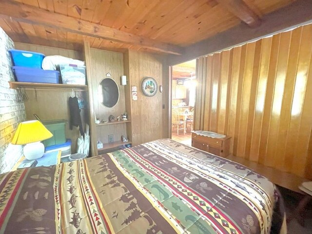25186 US-71 # 18, Park Rapids, MN 56470 - bedroom featuring wood ceiling, beamed ceiling, and wooden walls