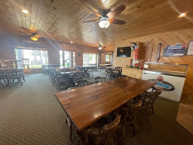 25186 US-71 # 18, Park Rapids, MN 56470 - dining area with ceiling fan, carpet, wooden ceiling, wooden walls, and a wall mounted air conditioner