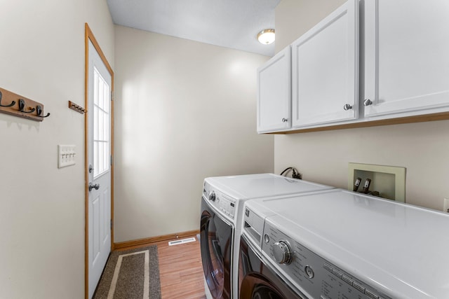 2737 Faulkner Dr, Chaska, MN 55318 - laundry room featuring cabinet space, washer and dryer, light wood-type flooring, and baseboards