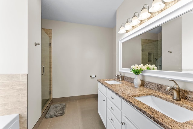 2737 Faulkner Dr, Chaska, MN 55318 - full bath featuring a stall shower, tile patterned floors, double vanity, baseboards, and a bathtub