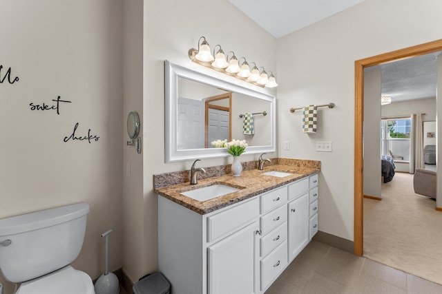 2737 Faulkner Dr, Chaska, MN 55318 - bathroom featuring toilet, ensuite bath, double vanity, and baseboards