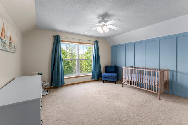 2737 Faulkner Dr, Chaska, MN 55318 - carpeted bedroom featuring vaulted ceiling, a crib, ceiling fan, and a textured ceiling