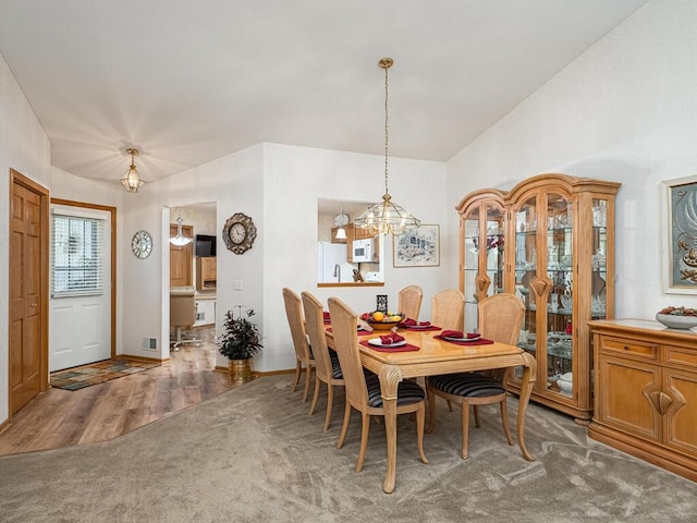 9349 Kimberly Ln N, Maple Grove, MN 55311 - dining room with vaulted ceiling, a chandelier, wood finished floors, and baseboards