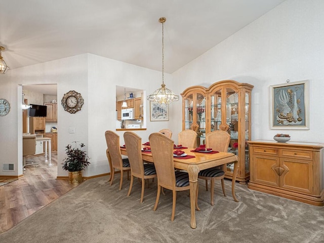 9349 Kimberly Ln N, Maple Grove, MN 55311 - dining room featuring lofted ceiling, a chandelier, wood finished floors, and baseboards