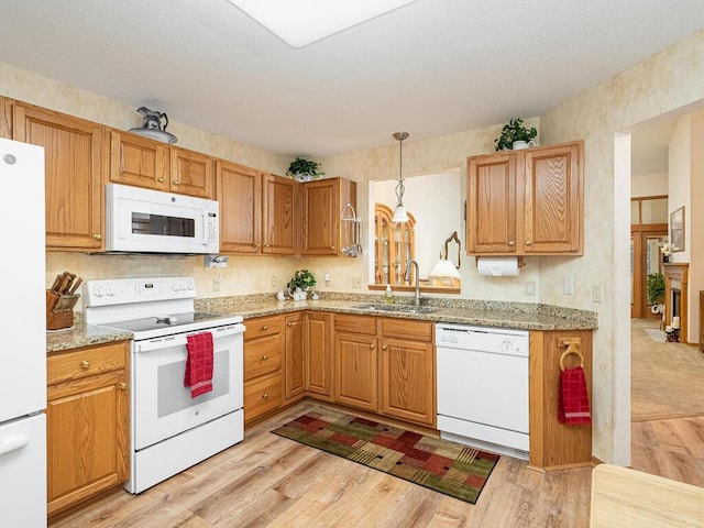 9349 Kimberly Ln N, Maple Grove, MN 55311 - kitchen featuring white appliances, a sink, light wood finished floors, hanging light fixtures, and light stone counters