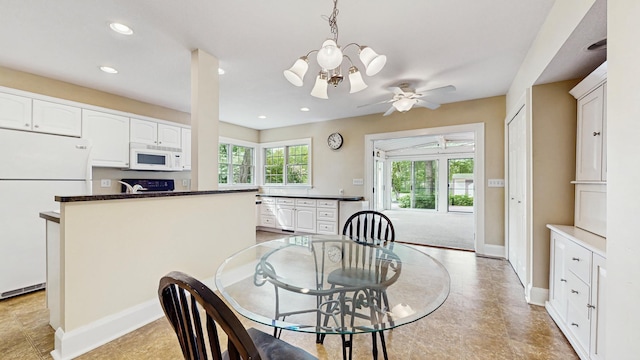 dining room with baseboards, recessed lighting, ceiling fan, and a chandelier