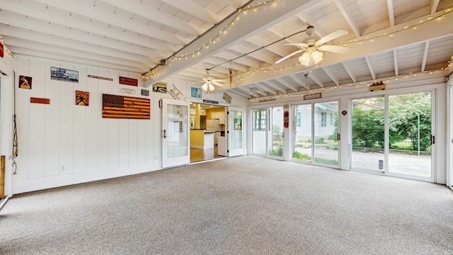 carpeted empty room featuring a ceiling fan, beamed ceiling, and wood ceiling