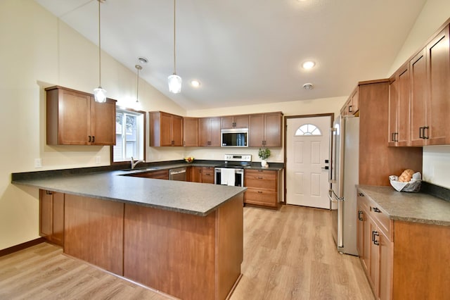 1212 7th St S, Waite Park, MN 56387 - kitchen with appliances with stainless steel finishes, a sink, a peninsula, dark countertops, and light wood-style flooring