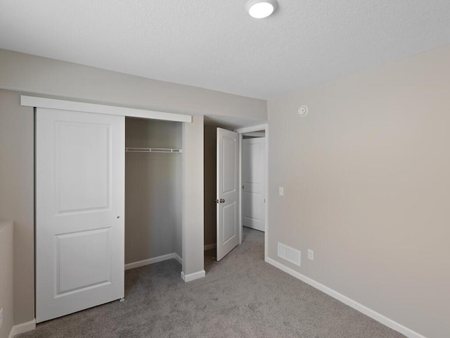 7463 147th Ln NW, Ramsey, MN 55303 - unfurnished bedroom with baseboards, carpet, a closet, and a textured ceiling