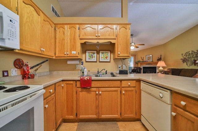 2506 Woodridge Ln, Brainerd, MN 56401 - kitchen with white appliances, vaulted ceiling, a sink, a ceiling fan, and light countertops