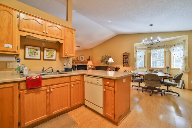 2506 Woodridge Ln, Brainerd, MN 56401 - kitchen featuring white dishwasher, a sink, a peninsula, a chandelier, and light wood-style flooring