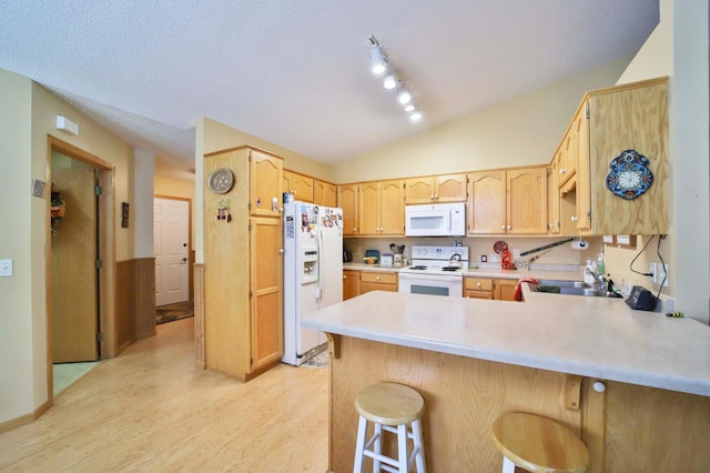 2506 Woodridge Ln, Brainerd, MN 56401 - kitchen with white appliances, a sink, a peninsula, light wood finished floors, and light countertops