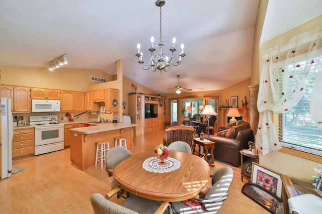 2506 Woodridge Ln, Brainerd, MN 56401 - dining space with vaulted ceiling, plenty of natural light, a chandelier, light wood-style floors, and a ceiling fan