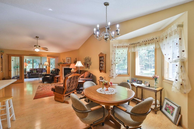 2506 Woodridge Ln, Brainerd, MN 56401 - dining space with light wood finished floors, vaulted ceiling, a chandelier, and ceiling fan